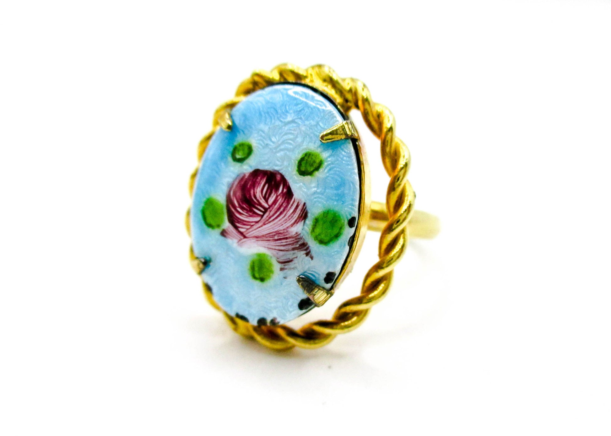 Ring with floral design and gold band on a white background